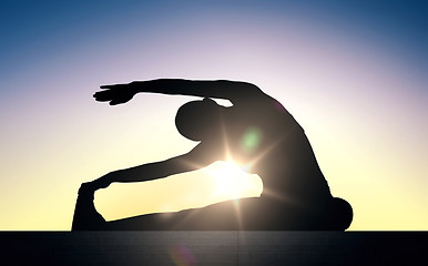 Image showing woman doing exercises on stairs over sun light