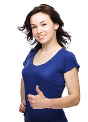 Image showing Woman is showing thumb up gesture