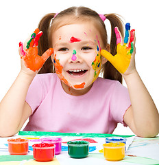 Image showing Portrait of a cute girl playing with paints