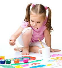 Image showing Cute cheerful child play with paints