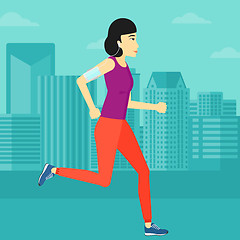 Image showing Woman jogging with earphones and smartphone.