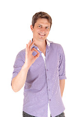 Image showing Smiling man giving OK with fingers.