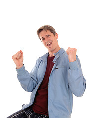 Image showing Happy young man with fists up.