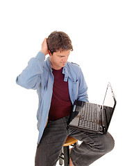 Image showing Man is wondering what is on the laptop.