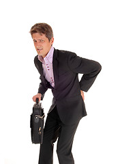 Image showing Businessman walking with back pain.