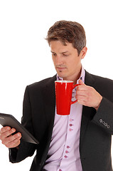 Image showing Closeup of businessman with red mug.