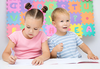 Image showing Children are writing on their books