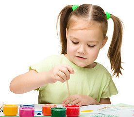 Image showing Cute cheerful child play with paints