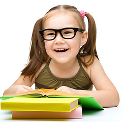 Image showing Little girl is reading a book