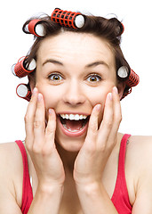 Image showing Woman is holding her face in astonishment