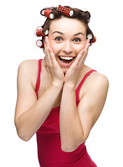 Image showing Woman is holding her face in astonishment