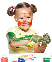 Image showing Portrait of a cute girl playing with paints