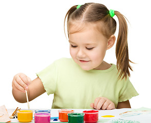 Image showing Cute cheerful child play with paints