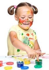 Image showing Portrait of a cute girl playing with paints