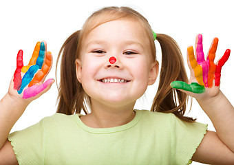 Image showing Portrait of a cute girl playing with paints