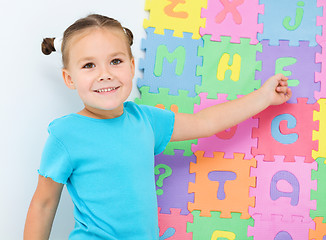 Image showing Little girl is showing letter E on the alphabet