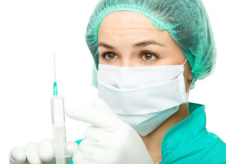 Image showing Young nurse is preparing syringe for injection