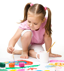 Image showing Cute cheerful child play with paints