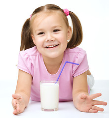 Image showing Cute little girl with a glass of milk