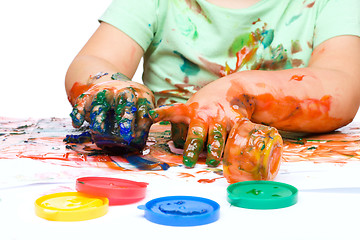 Image showing Little boy is playing with paints