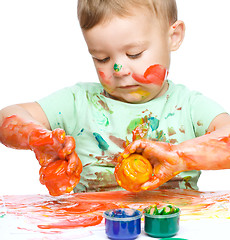 Image showing Little boy is playing with paints