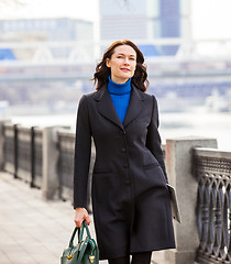 Image showing beautiful middle-aged woman in a dark coat