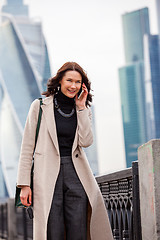 Image showing smiling middle-aged woman talking on a mobile phone