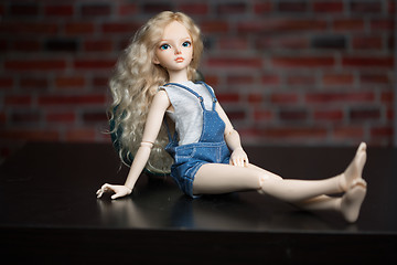 Image showing doll on a background of a brick wall.