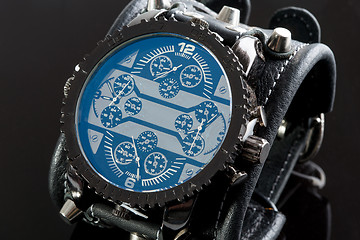 Image showing close-up of wristwatch on a black background