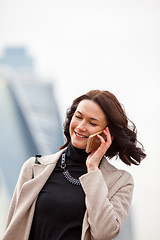 Image showing beautiful smiling woman talking on a mobile phone