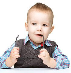 Image showing Little child play with book