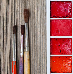 Image showing Three brushes for painting and a paint-box