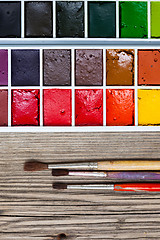 Image showing aquarelle paint box and three brushes