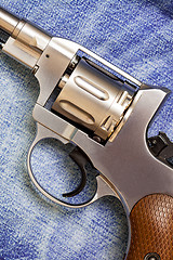 Image showing old revolver on blue jeans