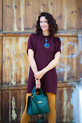 Image showing beautiful middle-aged woman in a burgundy dress 