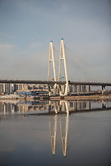 Image showing cable-stayed bridge reflected in the river