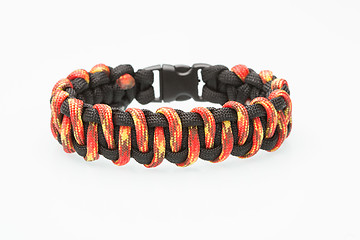 Image showing black and orange braided bracelet on white background