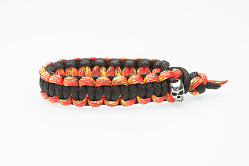 Image showing black and orange braided bracelet on white background