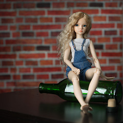 Image showing doll with a bottle. the concept of alcoholism