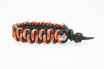 Image showing black and orange braided bracelet on white background