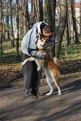 Image showing Man and joyful dog in public park