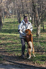 Image showing Man and joyful dog in public park