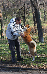 Image showing Man and joyful dog in public park