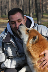 Image showing Man and joyful dog in public park