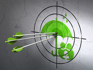 Image showing Safety concept: arrows in Family And Umbrella target on wall background