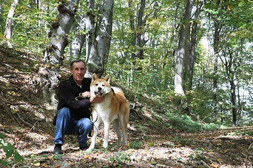 Image showing Man and dog enjoying in the forest