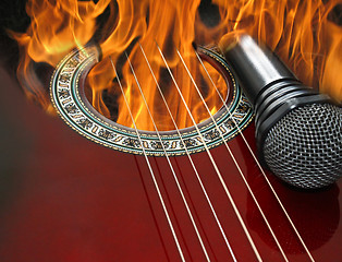 Image showing guitar and microphone burning in the fire