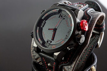 Image showing close-up of wristwatch on a black background