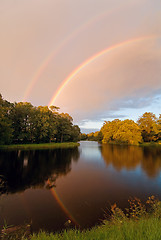 Image showing rainbow over autumn pond