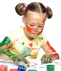 Image showing Portrait of a cute girl playing with paints